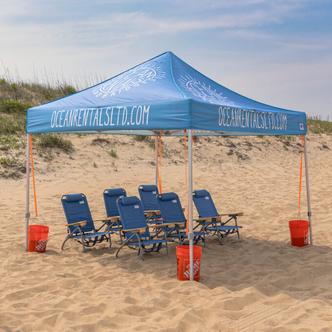 Beach cabana with six beach chairs set up on Sandbridge Beach